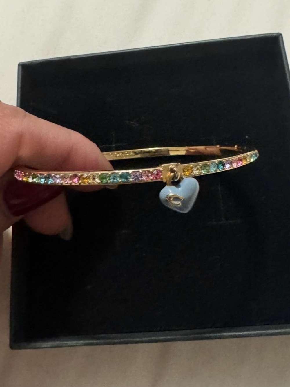 Coach Gold-Tone Rainbow Crystal Bangle with Light Blue Heart Charm